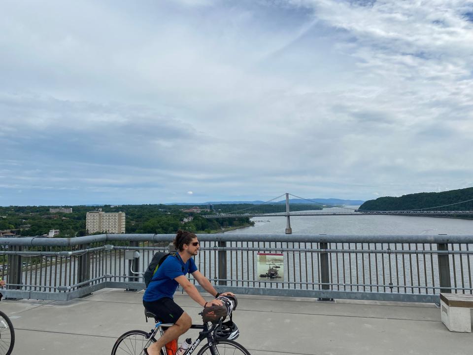 Pedestrians and bikers on the Walkway Over the Hudson enjoy gorgeous views of the Hudson River. The footbridge in Poughkeepsie, N.Y., rises 212 feet above the river.