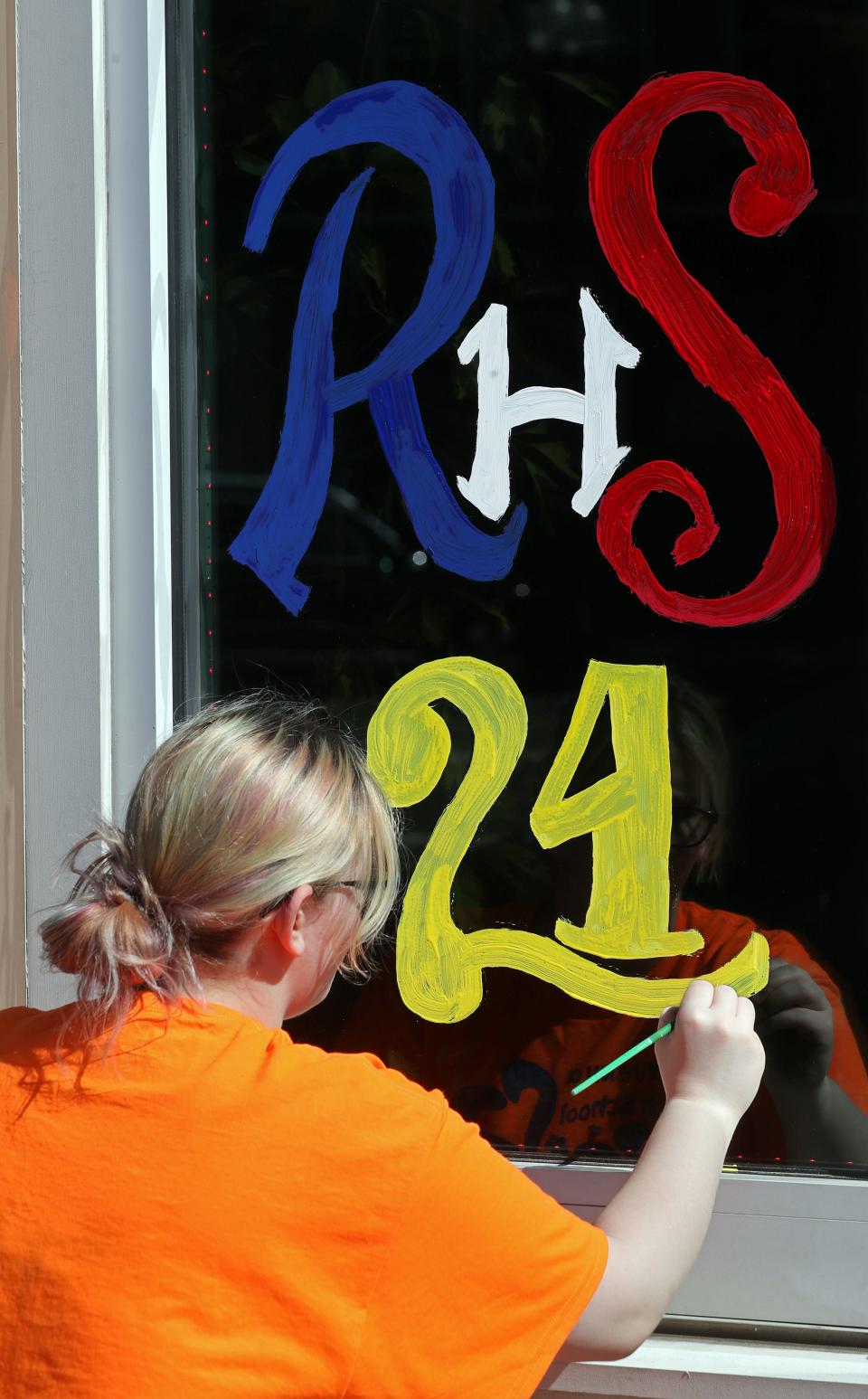 Ravenna junior Kennedy Miller puts the finishing touches on her painting Friday, May 10, 2024, in Ravenna.