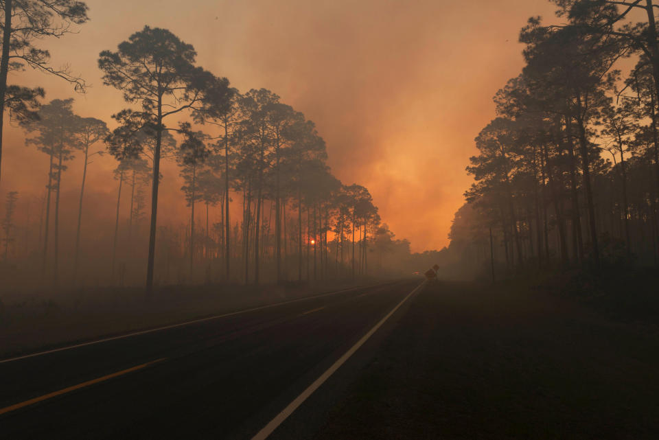 Smoke is seen during sunset as the West Mims fire burns in the Okefenokee National Wildlife Refuge, Georgia, U.S. in a photo released April 29, 2017. Fish and Wildlife Service/Mark Davis/Handout via REUTERS FOR EDITORIAL USE ONLY. NOT FOR SALE FOR MARKETING OR ADVERTISING CAMPAIGNSTHIS IMAGE HAS BEEN SUPPLIED BY A THIRD PARTY. IT IS DISTRIBUTED, EXACTLY AS RECEIVED BY REUTERS, AS A SERVICE TO CLIENTS