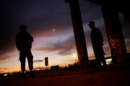 Soldiers assigned to the National Guard keep watch as part of an ongoing operation to prevent migrants from crossing illegally into the United States, in Ciudad Juarez