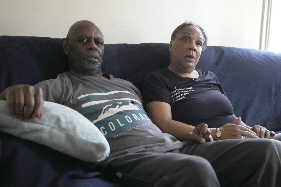 Jennifer Jones and Stan Bailey sit in their small flat in London, Thursday, Aug. 25, 2022. Like millions of people, Jones, 54, is struggling to cope as energy and food prices skyrocket during Britain's worst cost-of-living crisis in a generation. The former school supervisor has health problems and relies on government benefits to get by, but her welfare payments are nowhere near enough to cover her sharply rising bills. (AP Photo/Frank Augstein)