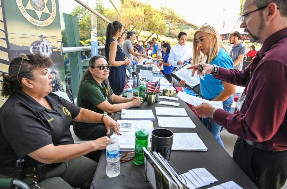 Job-seekers speak with prospective employers during a job fair hosted by Workforce Connection and the City of Fresno in response to the laying off of 300 Fresno employees from Bitwise Industries, at Fresno City Hall on Friday, June 16. 2023. CRAIG KOHLRUSS/ckohlruss@fresnobee.com