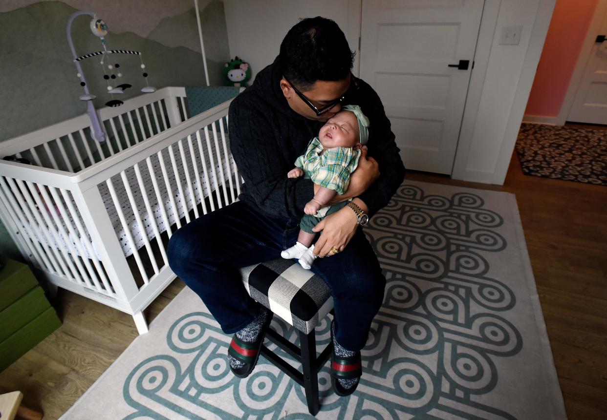 Renowned Nashville Chef Arnold Myint cuddles his daughter, Henley, on Tuesday, Nov. 21, 2023, in Nashville, Tenn.