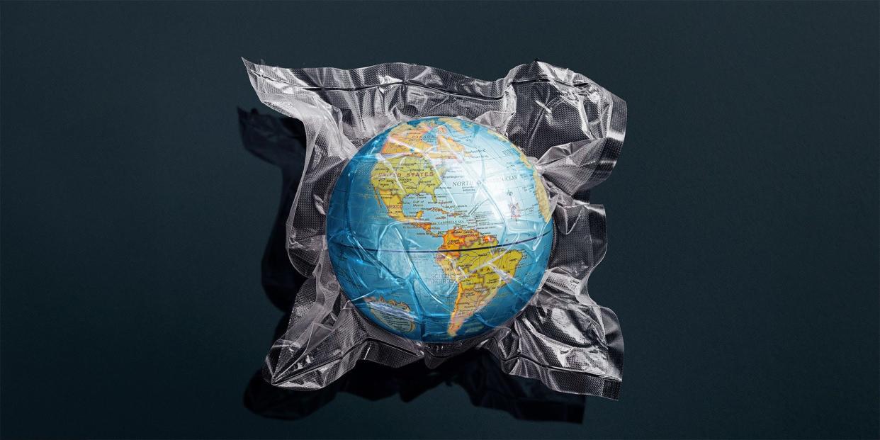 A photo illustration of the Earth in a shrink-wrapped plastic bag.