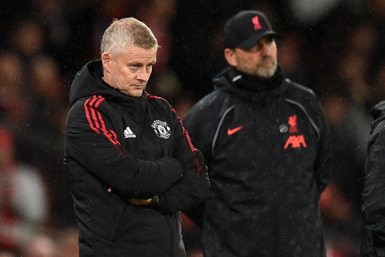 Manchester United's Norwegian manager Ole Gunnar Solskjaer (left) and Liverpool's German manager Jurgen Klopp look on during their English Premier League match.