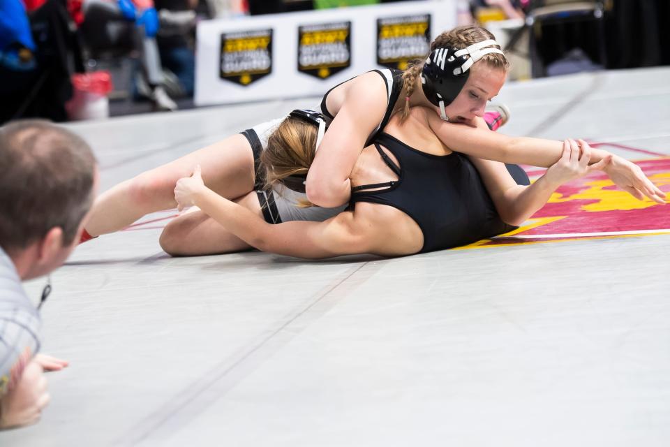 York Suburban's Alysiana Price-Ierley (top) wrestles to a 9-3 decision over Northern Bedford's Kaylee Ebersole in a 106-pound quarterfinal round bout at the PIAA Class Girls' Wrestling Championships at the Giant Center on March 8, 2024, in Hershey.