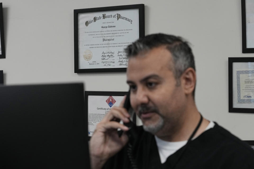 George Tadross, part-owner and pharmacy manager at MAC Pharmacy, works at his computer at the pharmacy, Wednesday, May 29, 2024, in Cleveland. (AP Photo/Sue Ogrocki)