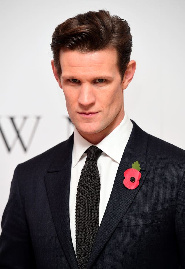 Matt Smith in black suit with poppy on his lapel