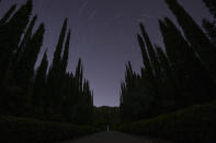 The monument where is placed the heart of French Baron Pierre de Coubertin is seen under the night sky in ancient Olympia, early Wednesday, April 10, 2024. Just outside the site of the ancient Olympic Games, hooting owls break the night-time silence at a white marble monument containing what's left of a singular Frenchman's heart. (AP Photo/Petros Giannakouris)