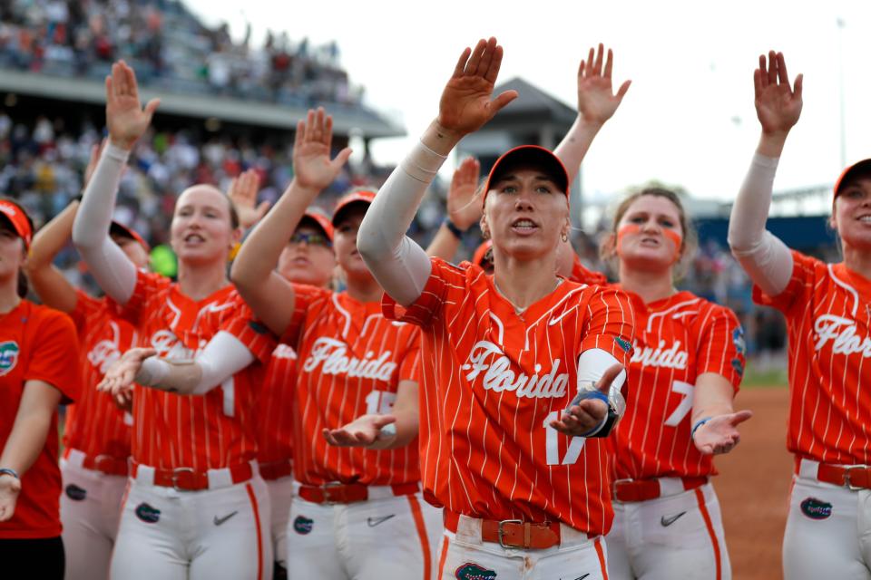 Florida's Skylar Wallace (17) leads the Gators in celebration following their win over Alabama in Sunday's elimination game at the Women's College World Series.