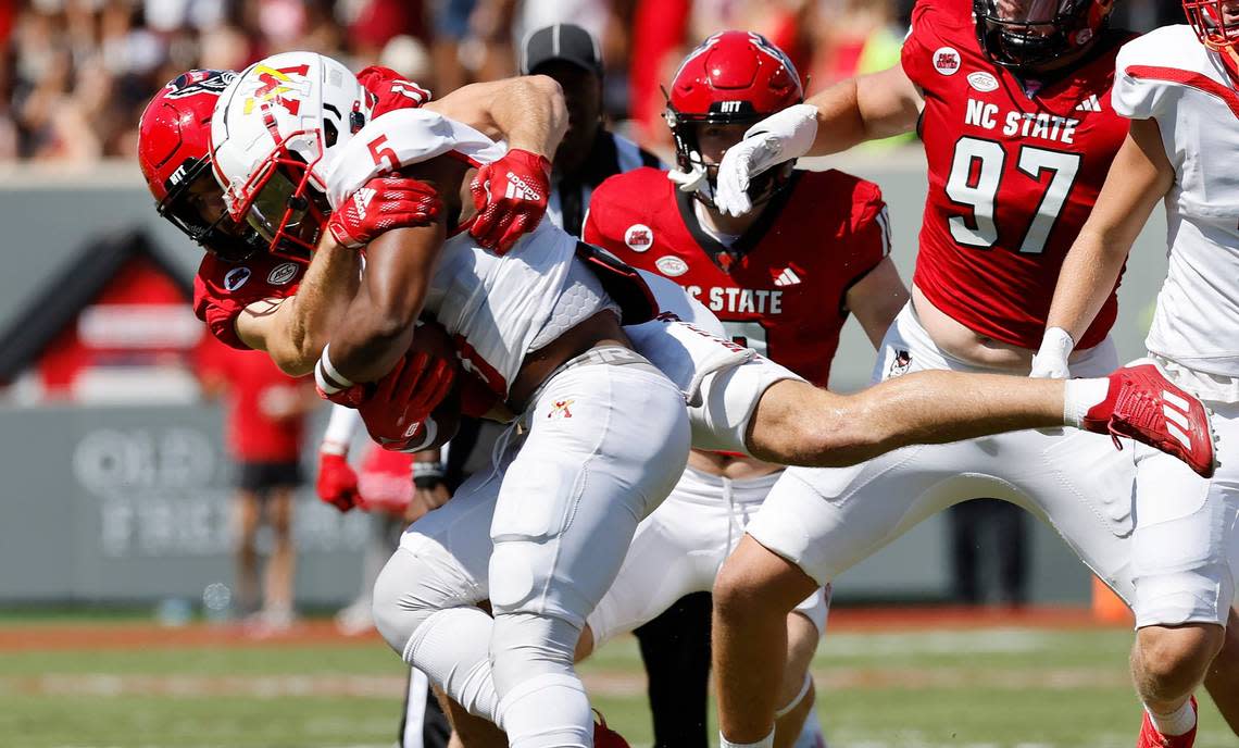 N.C. State linebacker Payton Wilson (11) wraps up Virginia Military Institute running back Rashad Raymond (5) during the first half of N.C. State’s game against VMI at Carter-Finley Stadium in Raleigh, N.C., Saturday, Sept. 16, 2023.