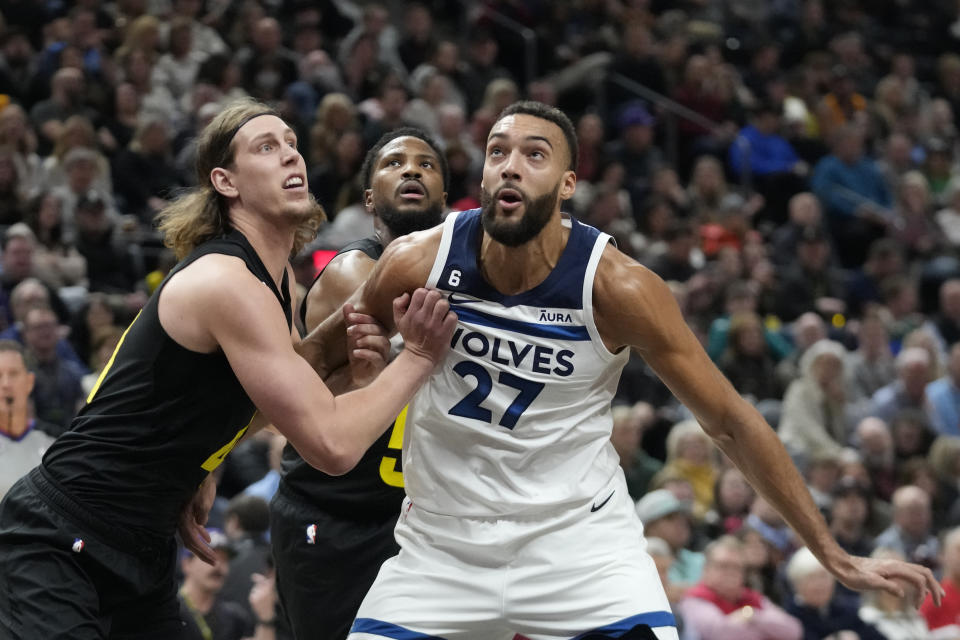 Utah Jazz forward Kelly Olynyk, left, and Minnesota Timberwolves center Rudy Gobert (27) look for a rebound during the first half of an NBA basketball game Friday, Dec. 9, 2022, in Salt Lake City. (AP Photo/Rick Bowmer)