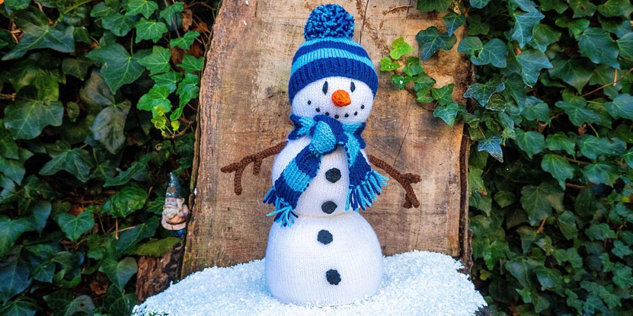 a knitted snowman with a hat and scarf