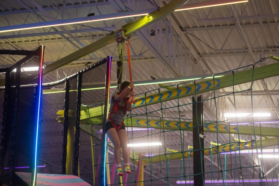 A young girl enjoys the zipline at Urban Air Amusement Park in Amarillo.
