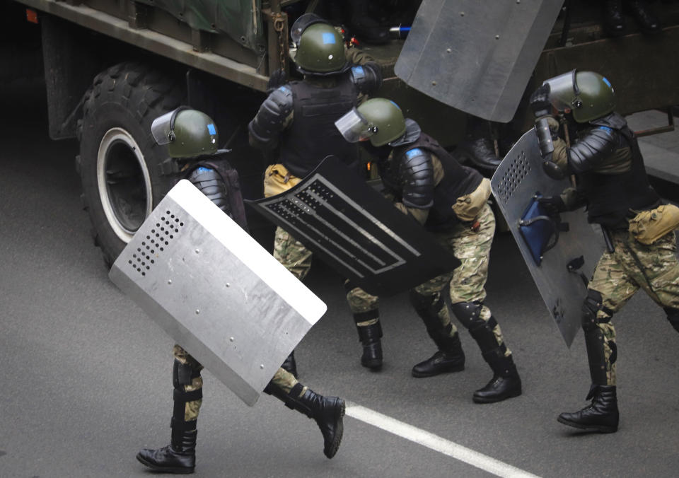 Belarusian police block a street during an opposition rally to protest the official presidential election results in Minsk, Belarus, Sunday, Oct. 25, 2020. The demonstrations were triggered by official results giving President Alexander Lukashenko 80% of the vote in an Aug. 9 election that the opposition insists was rigged. Lukashenko, who has ruled Belarus with an iron fist since 1994, has accused the United States and its allies of fomenting unrest in the ex-Soviet country. (AP Photo)