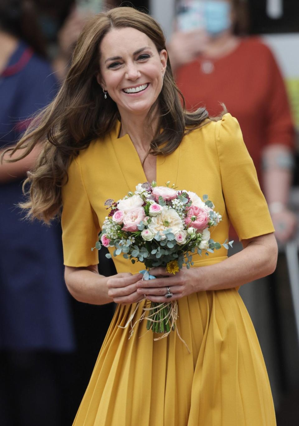 Catherine, Princess of Wales smiles as shedeparts the maternity unit after a visit to the Royal Surrey County Hospital