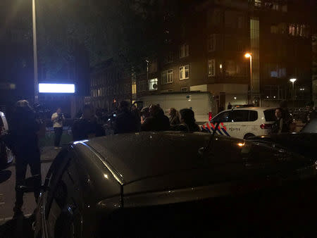 People gather at the scene where police are investigating a van with Spanish licence plates containing gas canisters which was found near a Rotterdam venue where a rock concert was cancelled, in this handout picture obtained by Reuters August 23, 2017. Social Media/Handout via REUTERS ATTENTION EDITORS - THIS IMAGE HAS BEEN SUPPLIED BY A THIRD PARTY. NO RESALES. NO ARCHIVE.