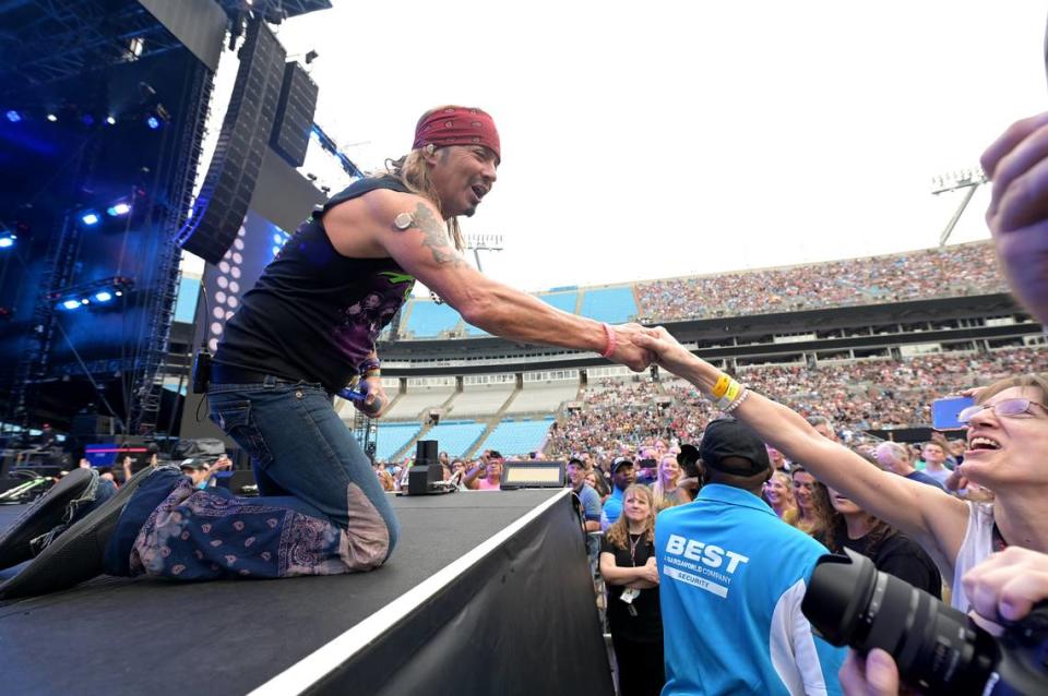 Poison lead singer Bret Michaels reaches out to shake hands with a fan during the band’s performance at The Stadium Tour 2022 at Bank of America Stadium in Charlotte, NC on Tuesday, June 28, 202. The concert featured Classless Act, Joan Jett and The Blackhearts, Motley Crue and Def Leppard.