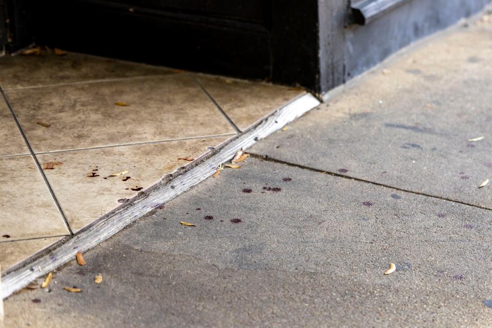 Drops of blood on the sidewalk in the Five Points South neighborhood following Saturday’s shooting. Police say the gunmen may have used ‘switches’ to allow their firearms to function as machine guns (AP)