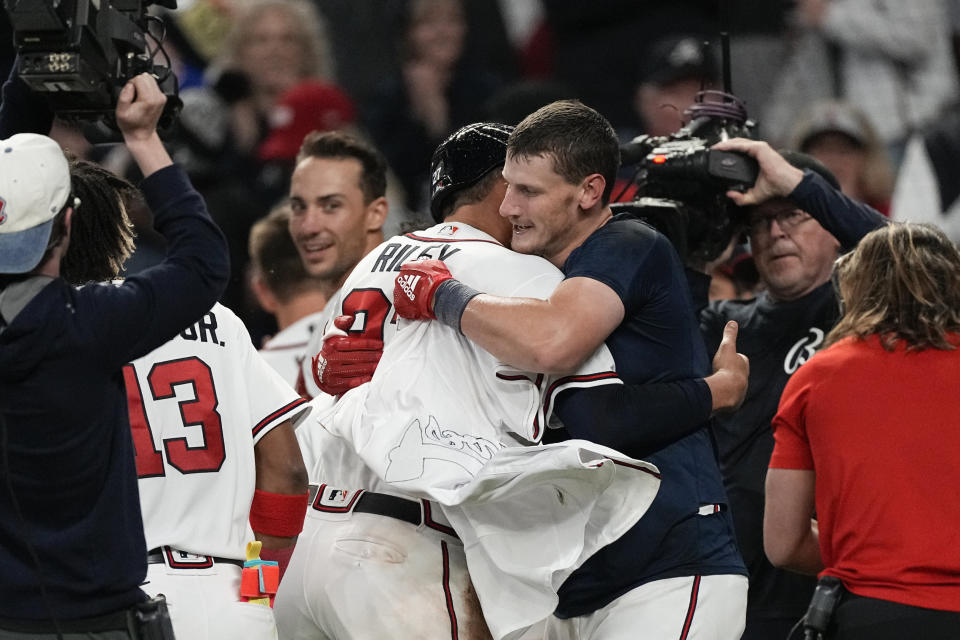 Atlanta Braves' Sean Murphy, center right, celebrates with Austin Riley after hitting a winning two-run home run in the 10th inning of a baseball game against the Cincinnati Reds, Monday, April 10, 2023, in Atlanta. (AP Photo/John Bazemore)