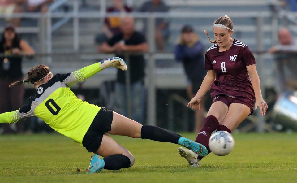 Walsh Jesuit's Reagan Pentz, right, scores a goal past Strongsville goalkeeper Abby Kudla during the second half of a soccer game, Wednesday, Aug. 24, 2022, in Cuyahoga Falls, Ohio.