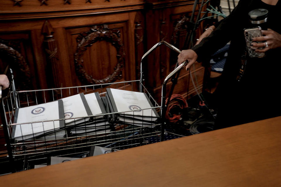 Binders full of notes, testimonies, talking points and more are distributed for Democratic members of Congress at the House Intelligence Committee hearing on the impeachment inquiry, in Washington, D.C., on Nov. 15, 2019. | Gabriella Demczuk for TIME