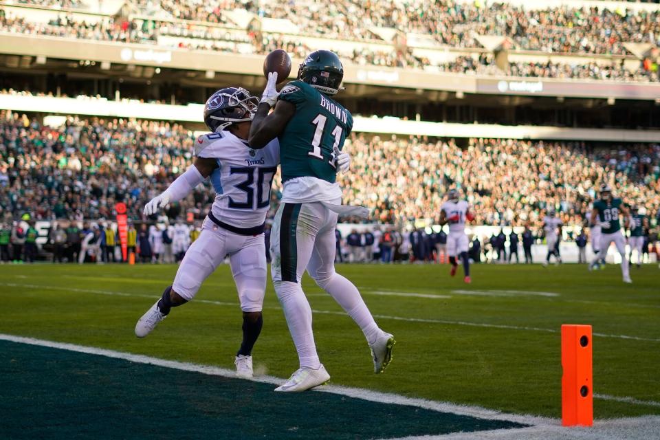 Philadelphia Eagles' A.J. Brown scores a touchdown in front of Tennessee Titans' Tre Avery during the second half of an NFL football game, Sunday, Dec. 4, 2022, in Philadelphia.