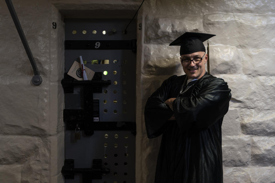 Eric Pomatton, who earned a bachelor's degree in communications through the Transforming Outcomes Project at Sacramento State (TOPSS), stands for a portrait outside his cell after a graduation ceremony at Folsom State Prison in Folsom, Calif., Thursday, May 25, 2023. (AP Photo/Jae C. Hong)