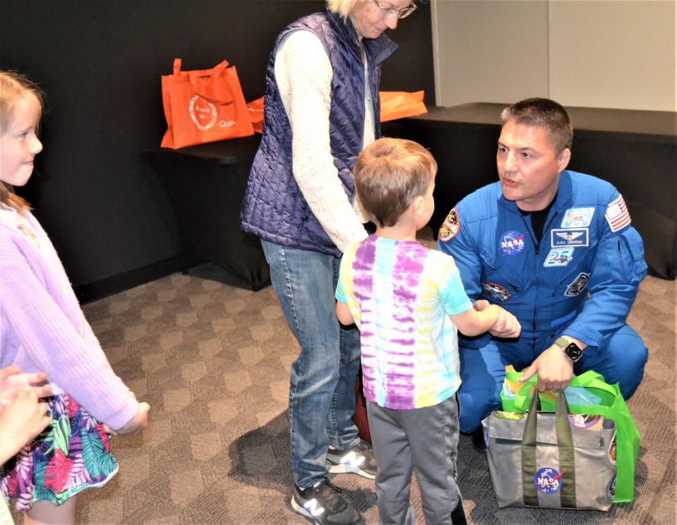 Astronaut Kjell Lindgren shakes hands with 5-year-old Anderson Barth after a presentation Thursday at the Fort Collins Museum of Discovery.
