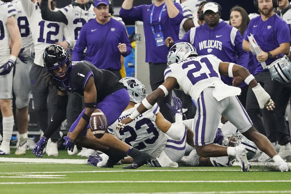 TCU wide receiver Quentin Johnston (1) and Kansas State safety Drake Cheatum (21) watch the ball following a fumble by TCU in the first half of the Big 12 Conference championship NCAA college football game, Saturday, Dec. 3, 2022, in Arlington, Texas. (AP Photo/LM Otero)