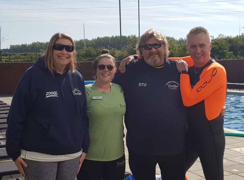 Stuart pictured here with his friend Andy and his swim and fitness coaches. (Collect/PA Real Life)