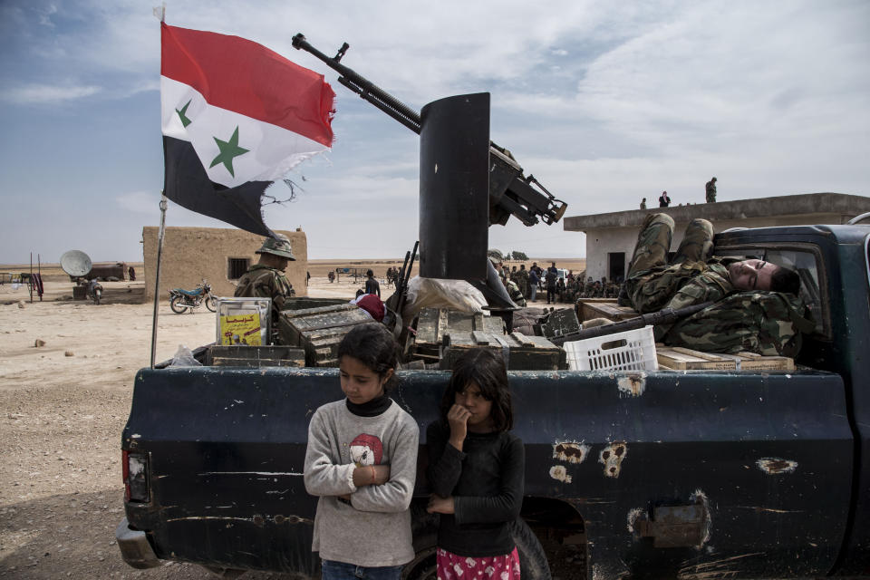 Syrian government forces deploy near the town of Tal Tamr, north Syria, Tuesday, Oct. 22, 2019. Russia and Turkey announced an agreement Tuesday to jointly patrol almost the entire northeastern Syrian border after the withdrawal of Kurdish fighters, cementing the two countries' power in Syria in the wake of President Donald Trump's abrupt withdrawal of U.S. forces. (AP Photo/Baderkhan Ahmad)