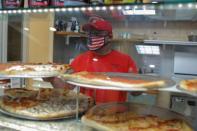 Sal Finocchiaro, 51, prepares pizza at Palermo Pizzeria and Restaurant, which he co-owns, on Staten Island in New York City