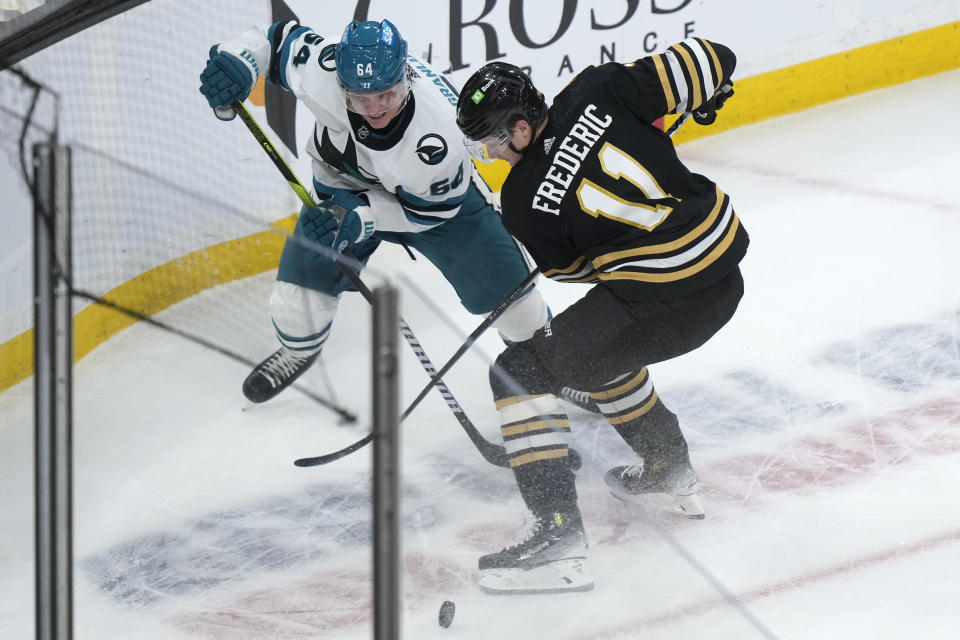 San Jose Sharks center Mikael Granlund vies for control of the puck with Boston Bruins center Trent Frederic (11) in the first period of an NHL hockey game, Thursday, Nov. 30, 2023, in Boston. (AP Photo/Steven Senne)