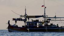 A Philippine flag on a fishing boat flutters at the disputed Scarborough Shoal April 5, 2017. Picture taken April 5, 2017. REUTERS/Erik De Castro