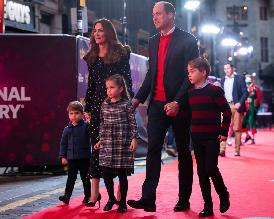 Prince William and Duchess Kate with their children, Prince Louis, Princess Charlotte and Prince George, at a pantomime performance at London's Palladium Theatre on Dec. 11, 2020, to thank key workers and families for their efforts during the COVID-19 pandemic.