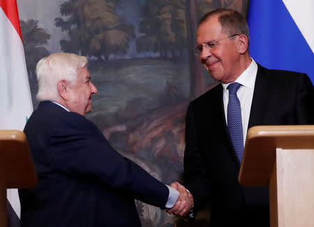 Russian Foreign Minister Sergei Lavrov shakes hands with Syrian Foreign Minister Walid al-Moualem during a joint news conference following their talks in Moscow, Russia August 30, 2018. REUTERS/Maxim Shemetov