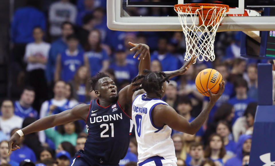 UConn forward Adama Sanogo (21) defends against Seton Hall guard Kadary Richmond (0) during the first half of an NCAA college basketball game in Newark, N.J., Wednesday, Jan. 18, 2023. (AP Photo/Noah K. Murray)