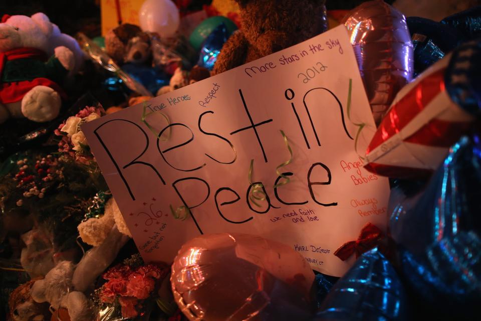 NEWTOWN, CT - DECEMBER 18: A sign adorns a memorial for shooting victims on December 18, 2012 in Newtown, Connecticut. Funeral services were held in Newtown Tuesday for Jessica Rekos and James Mattioli, both age six, four days after 20 children and six adults were killed at Sandy Hook Elementary School. (Photo by John Moore/Getty Images)