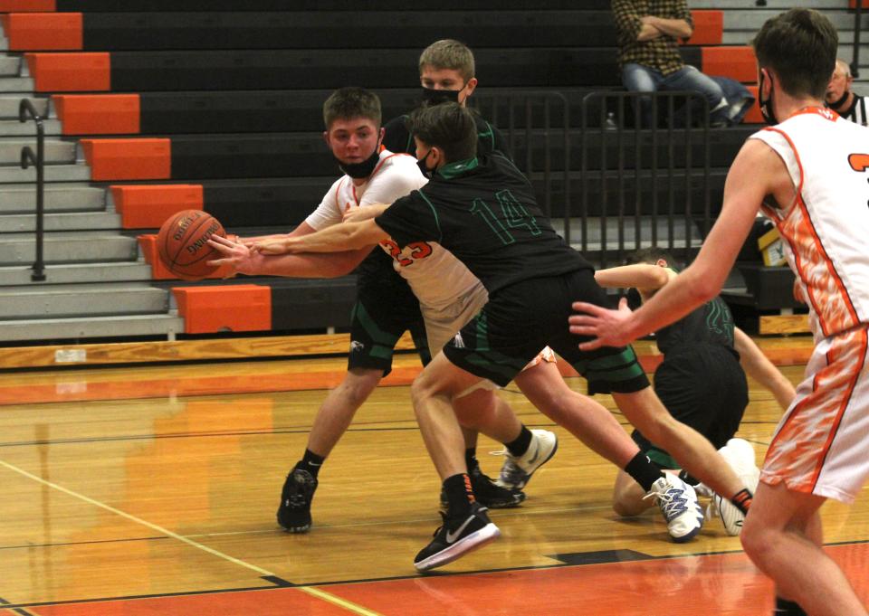 Wellsville's Logan Dunbar (23) looks to make a pass under heavy pressure from Fillmore's Zach Sisson (14) last season.