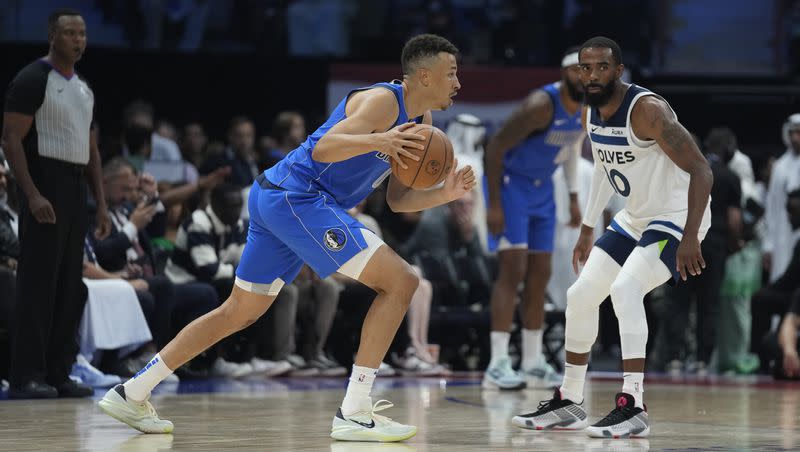 Dallas Mavericks guard Dante Exum s drives by Minnesota Timberwolves guard Mike Conley during a preseason game in Abu Dhabi, United Arab Emirates, on Thursday, Oct. 6, 2023. Exum, the former Utah Jazz lottery pick, is back in the league after spending two seasons honing his game overseas.