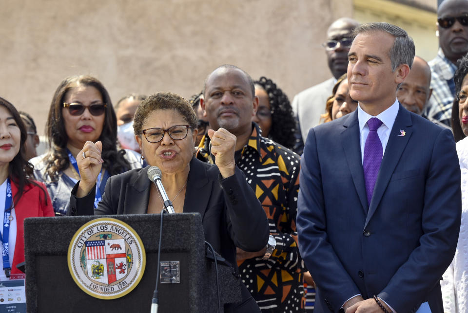 FILE - U.S. Rep. Karen Bass talks about the Los Angeles Riots as she stands next to Mayor Eric Garcetti during a press conference recognizing the 30th anniversary of the L.A. Riots at the corner of Florence Avenue and Normandie Avenue in Los Angeles, on Friday, April 29, 2022. Karen Bass, the first Black woman elected Los Angeles mayor, will be sworn-in as the 43rd Mayor of Los Angeles by Vice President Kamala Harris in an historic ceremony on Sunday, Dec. 11. (Jeff Gritchen/The Orange County Register via AP, File)