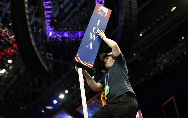 Scott Kiss installs the Iowa state delegation sign on the floor of the Republican National Convention in Tampa, Fla., August 26, 2012. This year's convention starts on August 28. (Photo: Mike Segar/Reuters)