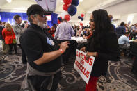 Wisconsin Republican gubernatorial supporters Joe Traficange from West Allis and Veronica Diaz from MIlwaukee catch up during the election night party at the Italian Community Center in Milwaukee Tuesday, Nov. 8, 2022, in Milwaukee. (AP Photo/Kenny Yoo)