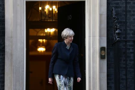 Britain's Prime Minister Theresa May leaves to greet Qatar's Prime Minister and Minister of Interior Sheikh Abdullah Bin Nasser Al Thani at 10 Downing Street in London, Britain March 27, 2017. REUTERS/Neil Hall