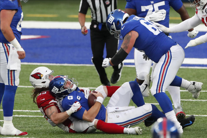 New York Giants quarterback Daniel Jones, bottom center, is sacked during the second half of an NFL football game against the Arizona Cardinals, Sunday, Dec. 13, 2020, in East Rutherford, N.J. (AP Photo/Noah K. Murray)
