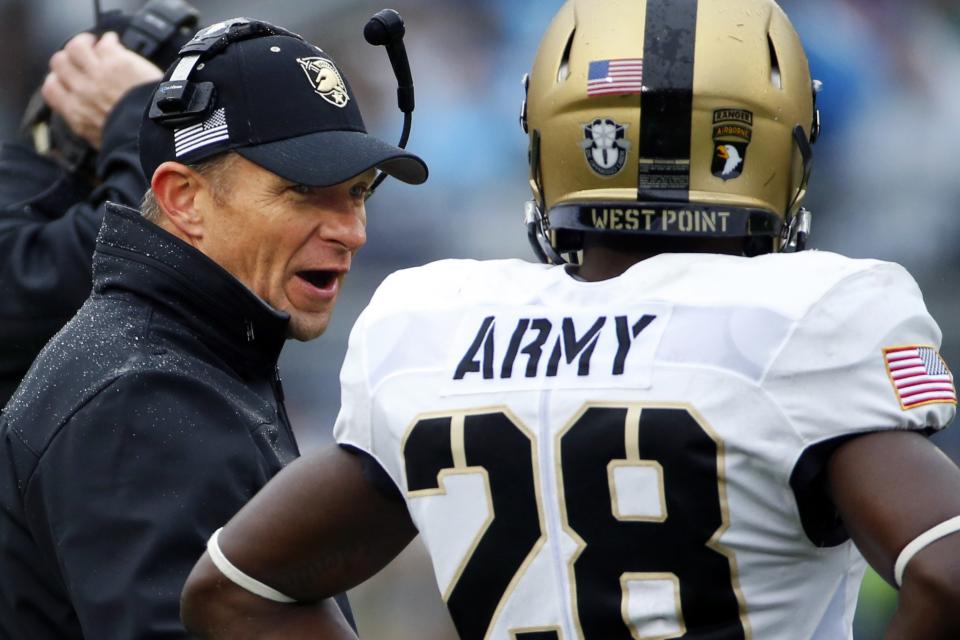 Army head coach Jeff Monken , left, talks with Army cornerback Brandon Jackson (28) during the first half against Penn State, Oct. 3, 2015. (AP Photo/Gene J. Puskar)