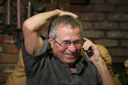 University of Southern California professor Arieh Warshel talks on the phone with Israeli President Shimon Peres after hearing he won the Nobel chemistry prize in Los Angeles, California October 9, 2013. REUTERS/Lucy Nicholson