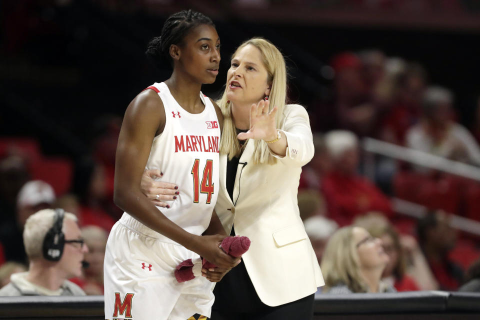 FILE - In this Jan. 6, 2020, file photo, Maryland head coach Brenda Frese, right, talks with guard Diamond Miller during the second half of an NCAA college basketball game against Ohio State in College Park, Md. For all the wealth, privilege and rewards elite sports can provide its participants, few vocations require more time away from loved ones. “I appreciate the gift of time and being able to spend it with my family,” said Maryland women's basketball coach Brenda Frese, whose fourth-ranked Terrapins might well have been in New Orleans last week for the Final Four. (AP Photo/Julio Cortez, File)