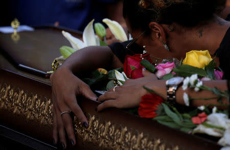 A relative reacts over the coffin of Rio de Janeiro's city councillor Marielle Franco, 38, who was shot dead, during her burial in Rio de Janeiro, Brazil March 15, 2018. REUTERS/Ricardo Moraes